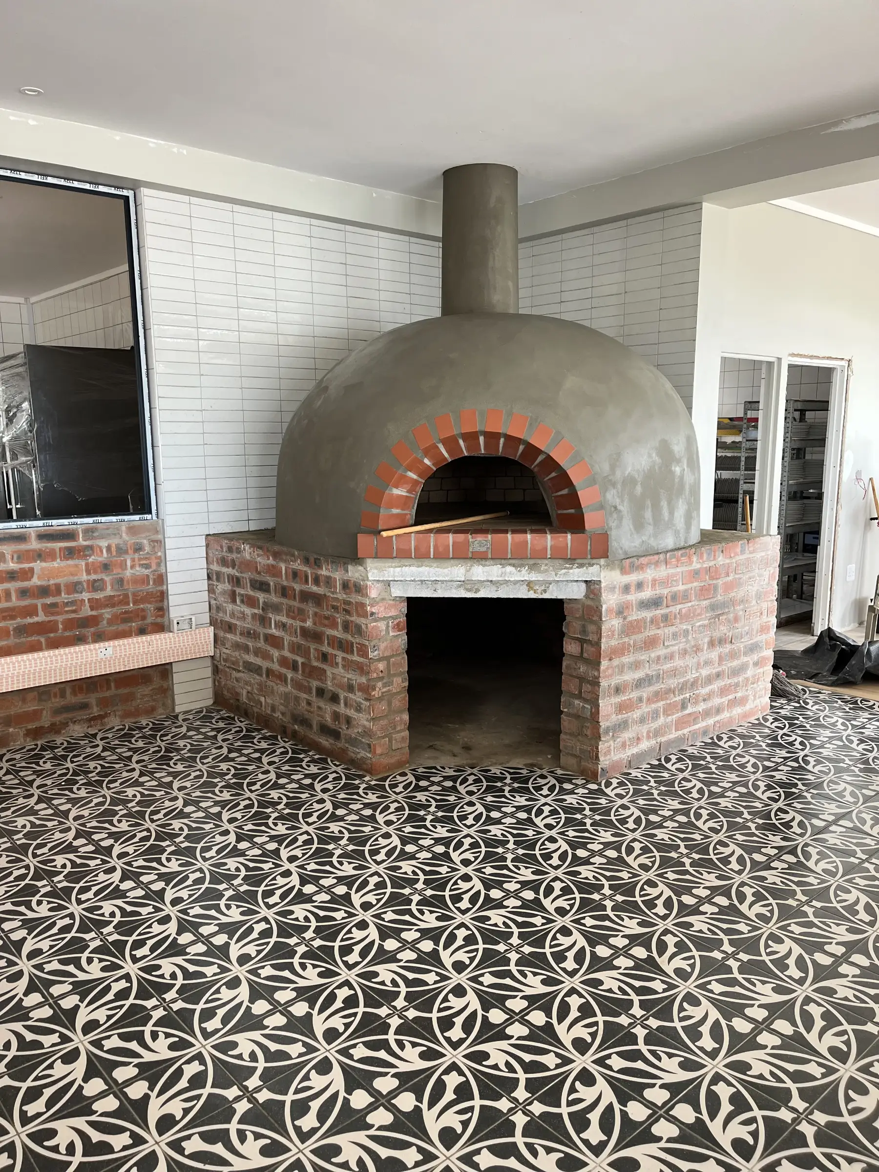 Brand new pizza oven on a modern tiled floor