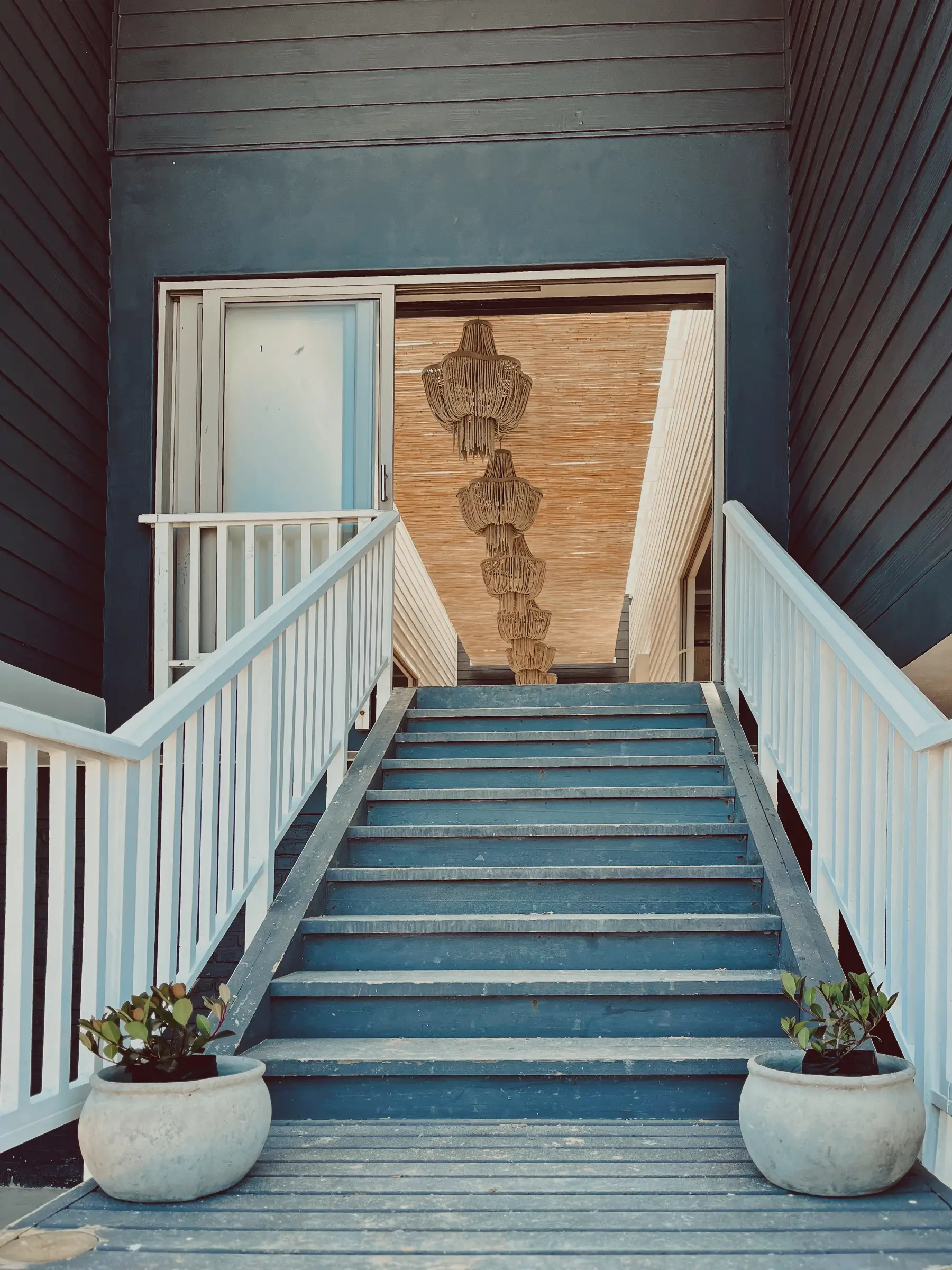 Newly renovated front entrance to Glentana building with matt-finish paint and white railings.
