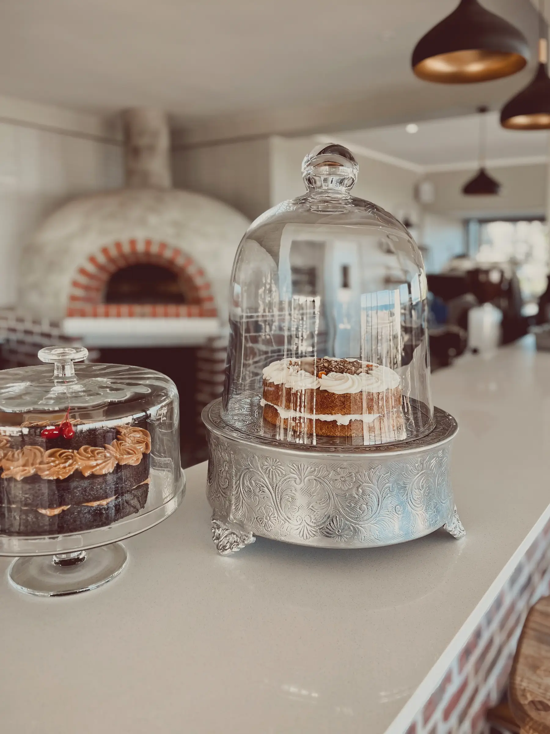 Cakes on display in beautiful glass-domed platters on the updated bar counter inside the Glentana building